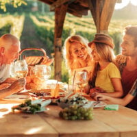 Family eating outside on a sunny deck