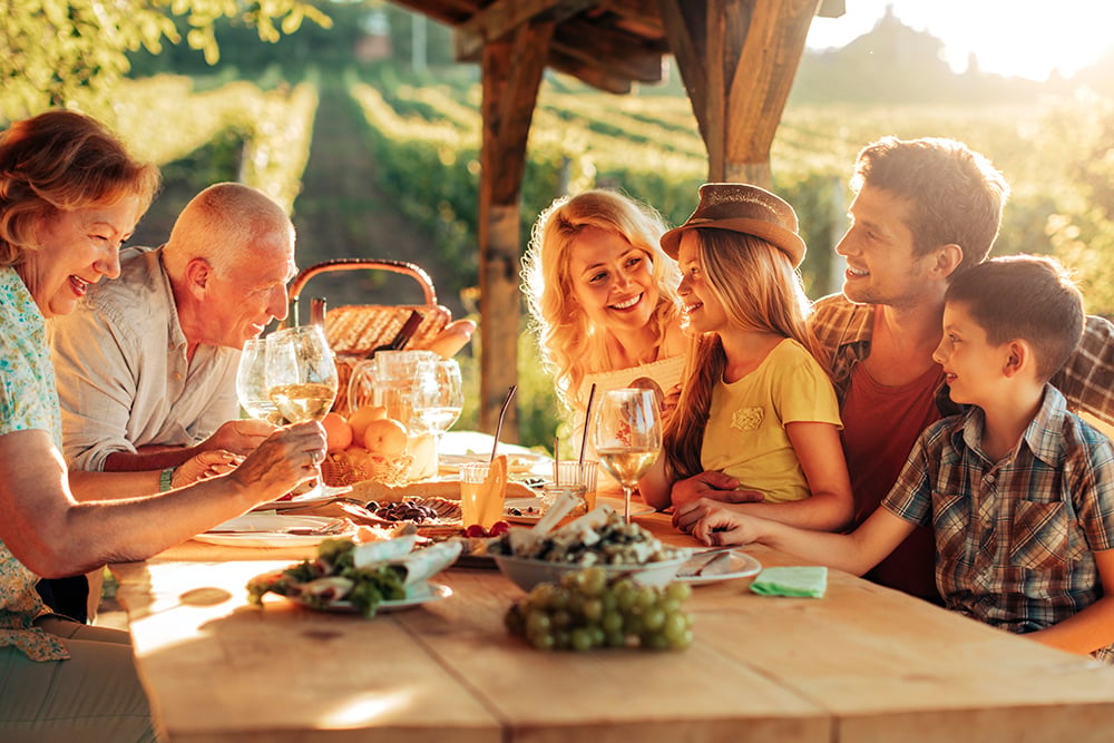 Family eating outside on a sunny deck